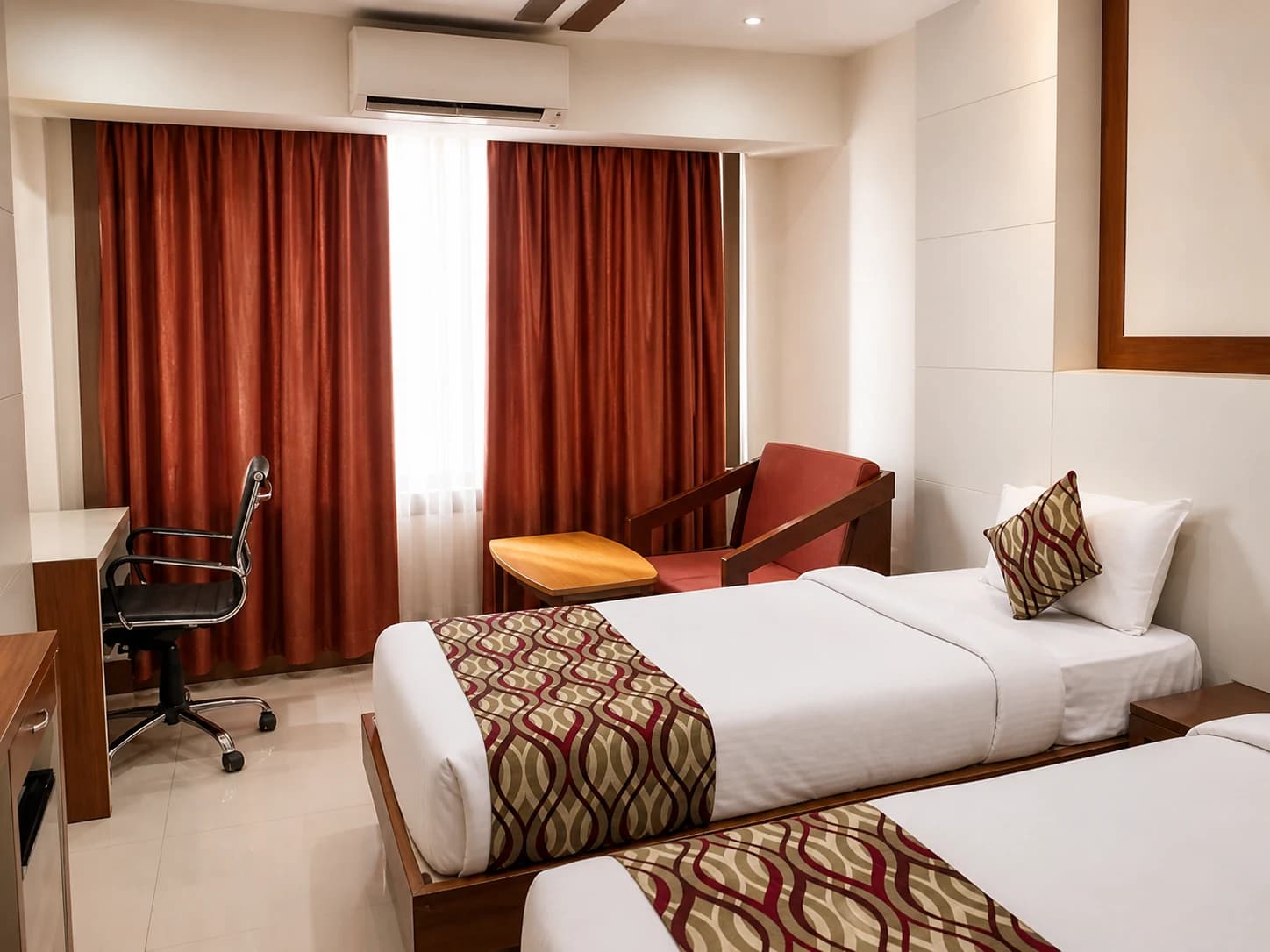 Deluxe Twin beds setup with modern lighting and side tables